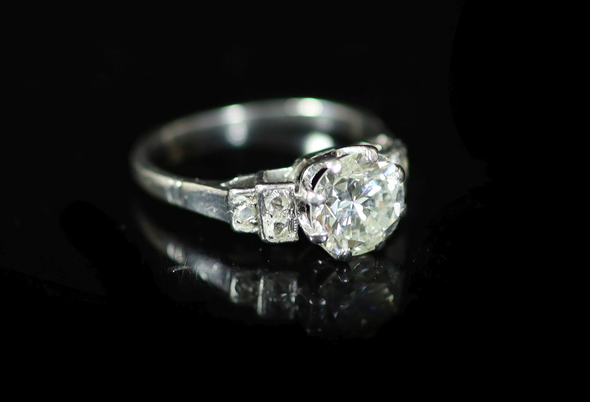 A platinum and single stone diamond ring, with six stone rose cut diamond set shoulders